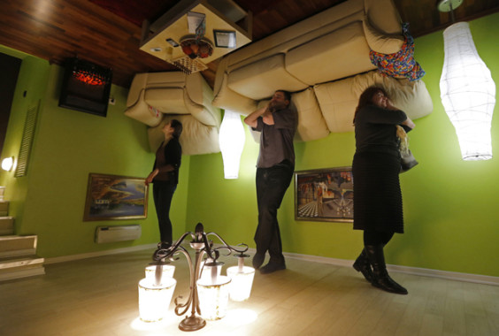 People take a tour in an "upside-down home"  in St. Petersburg